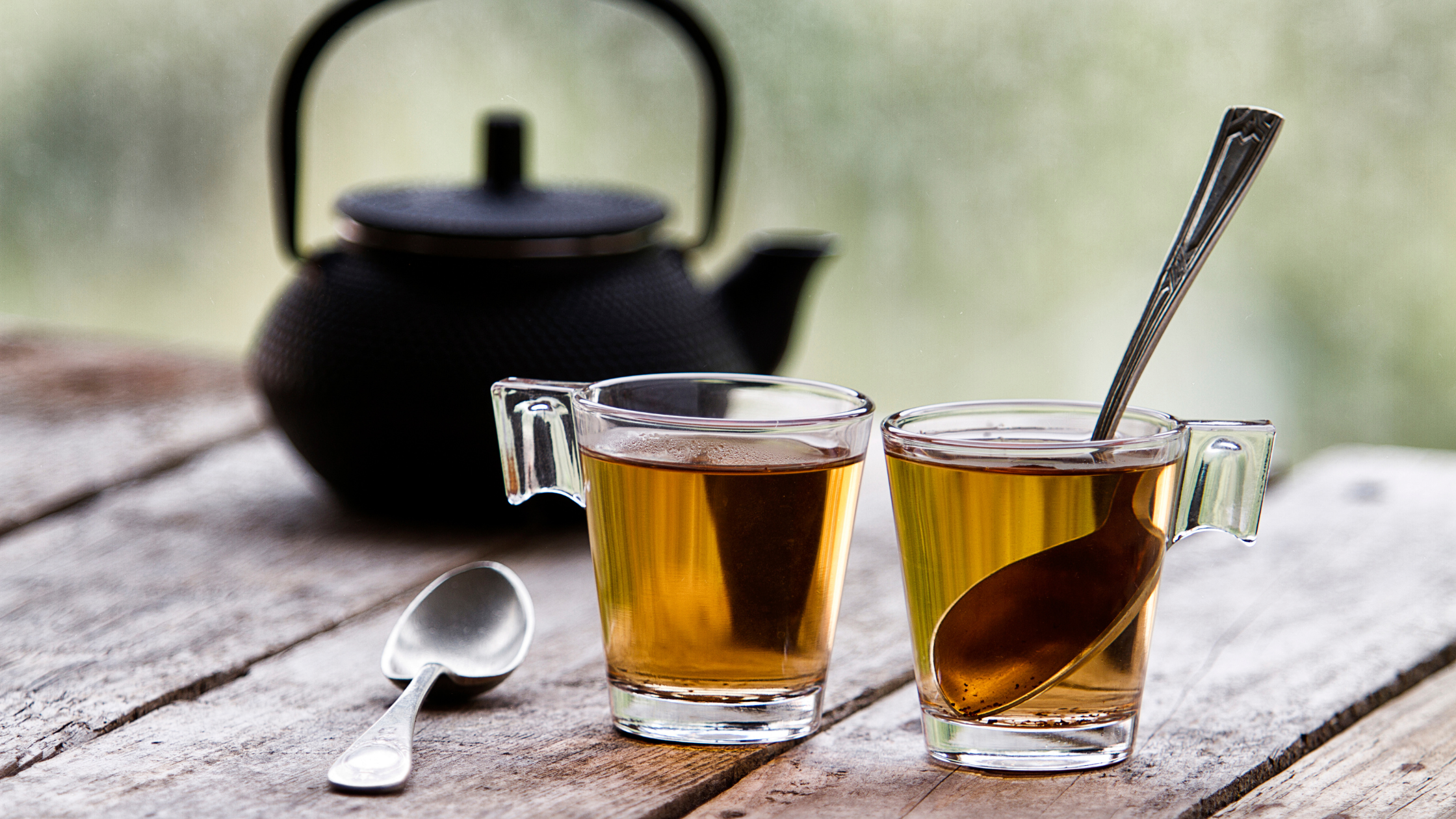 Featured Image: What Makes Rooibos Tea Proudly South African? Image of two cups of rooibos tea with black tea pot
